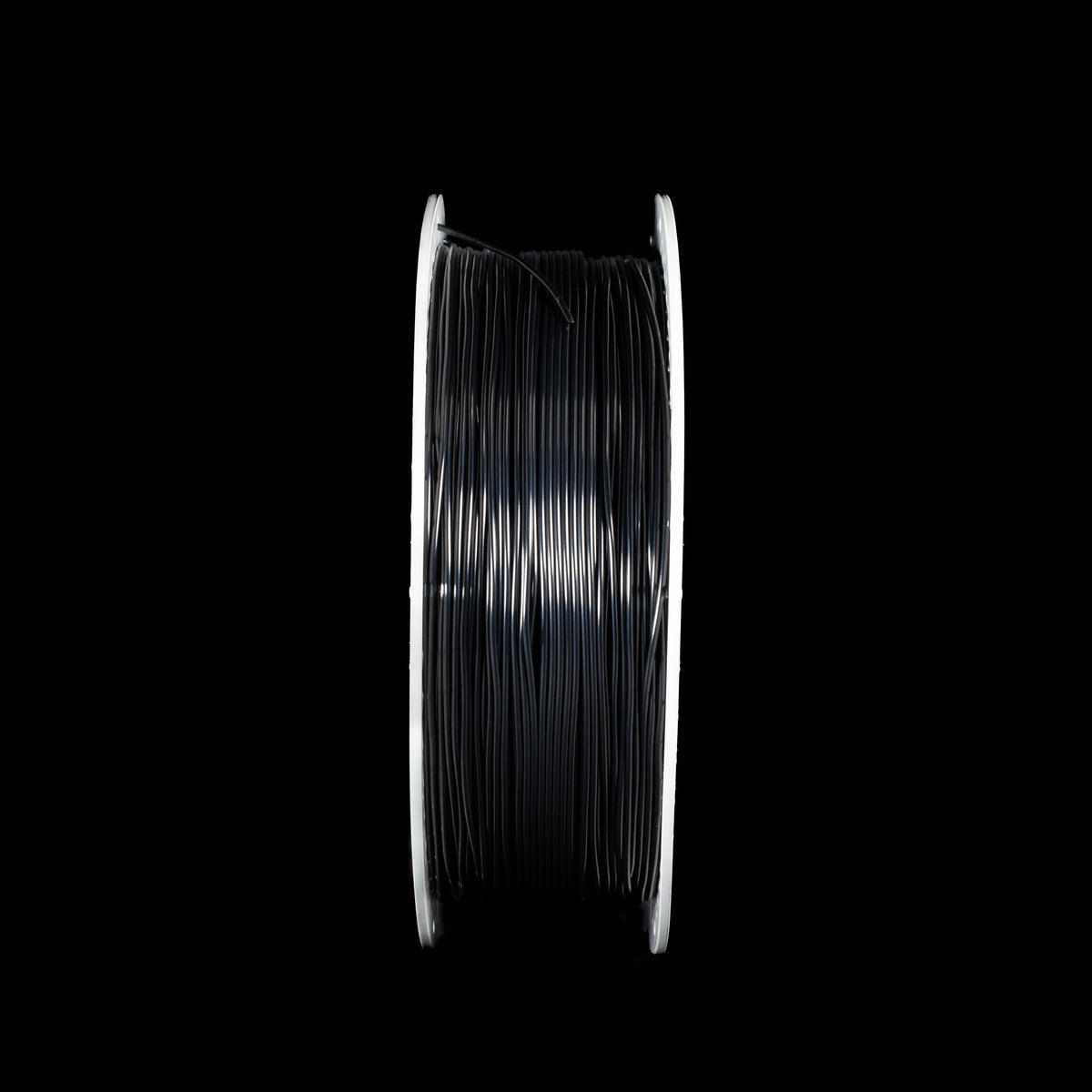 A spool of black 3D printer filament in black colour on a solid black background. 