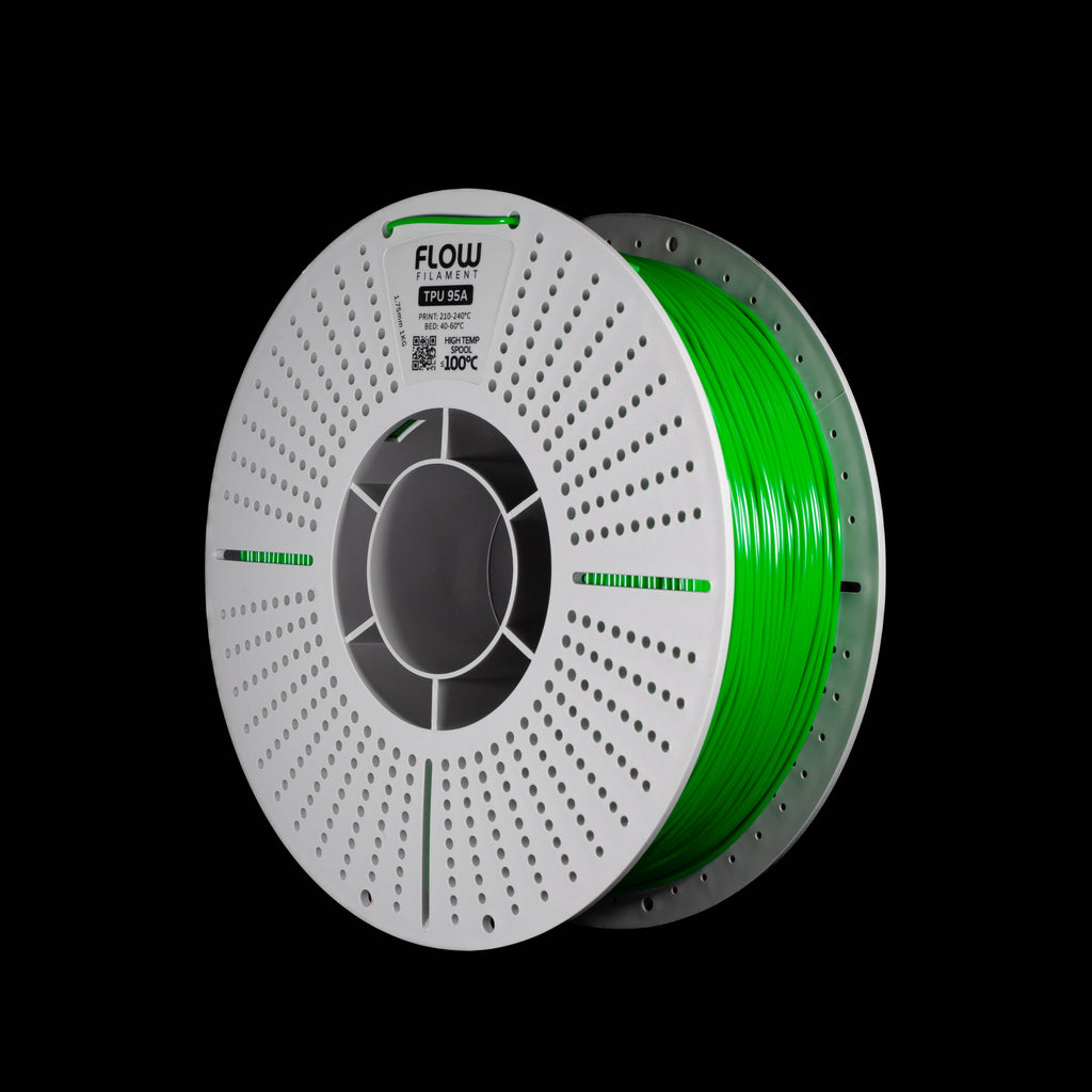A spool of emerald green 3D printing filament on a black background, with the FLOW brand name visible on the top of the perforated spool.