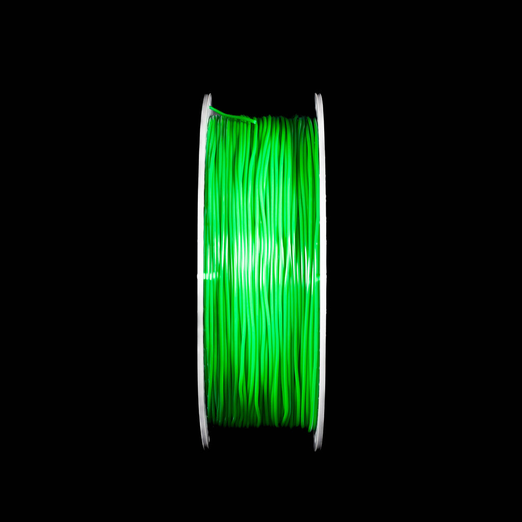 A spool of emerald green 3D printing filament centered against a solid black background.