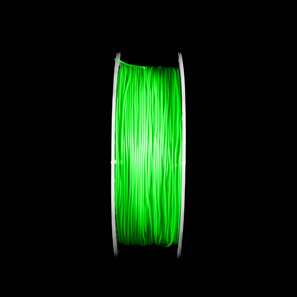 A spool of fluorescent bright neon green 3D printing filament, centered against a solid black background.