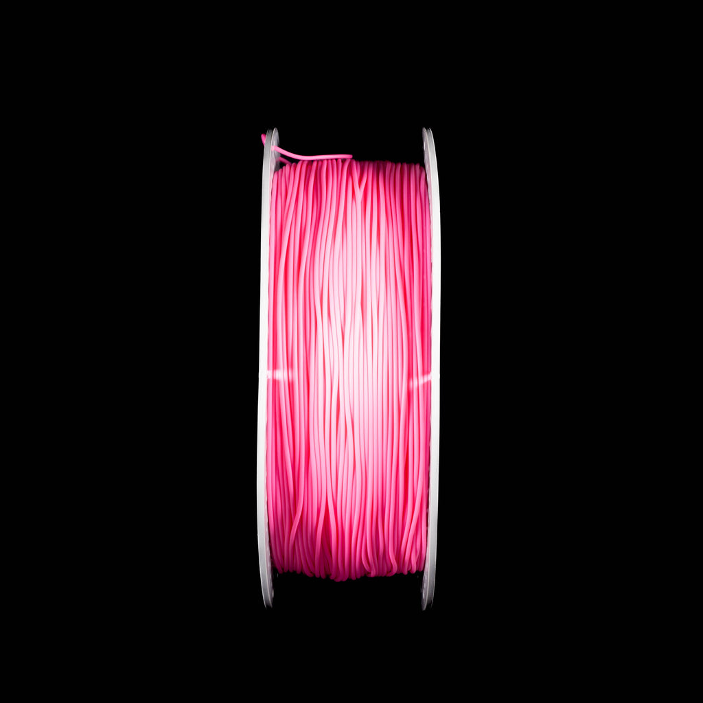 A spool of fluorescent bright rose red 3D printing filament wound on a white spool, centered against a solid black background.