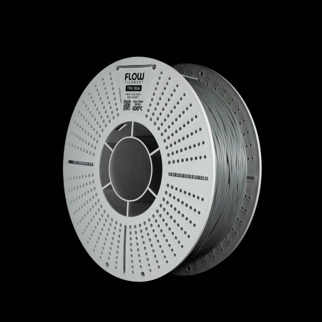A spool of grey 3D printer filament on a black background, featuring the FLOW brand logo printed on the top.