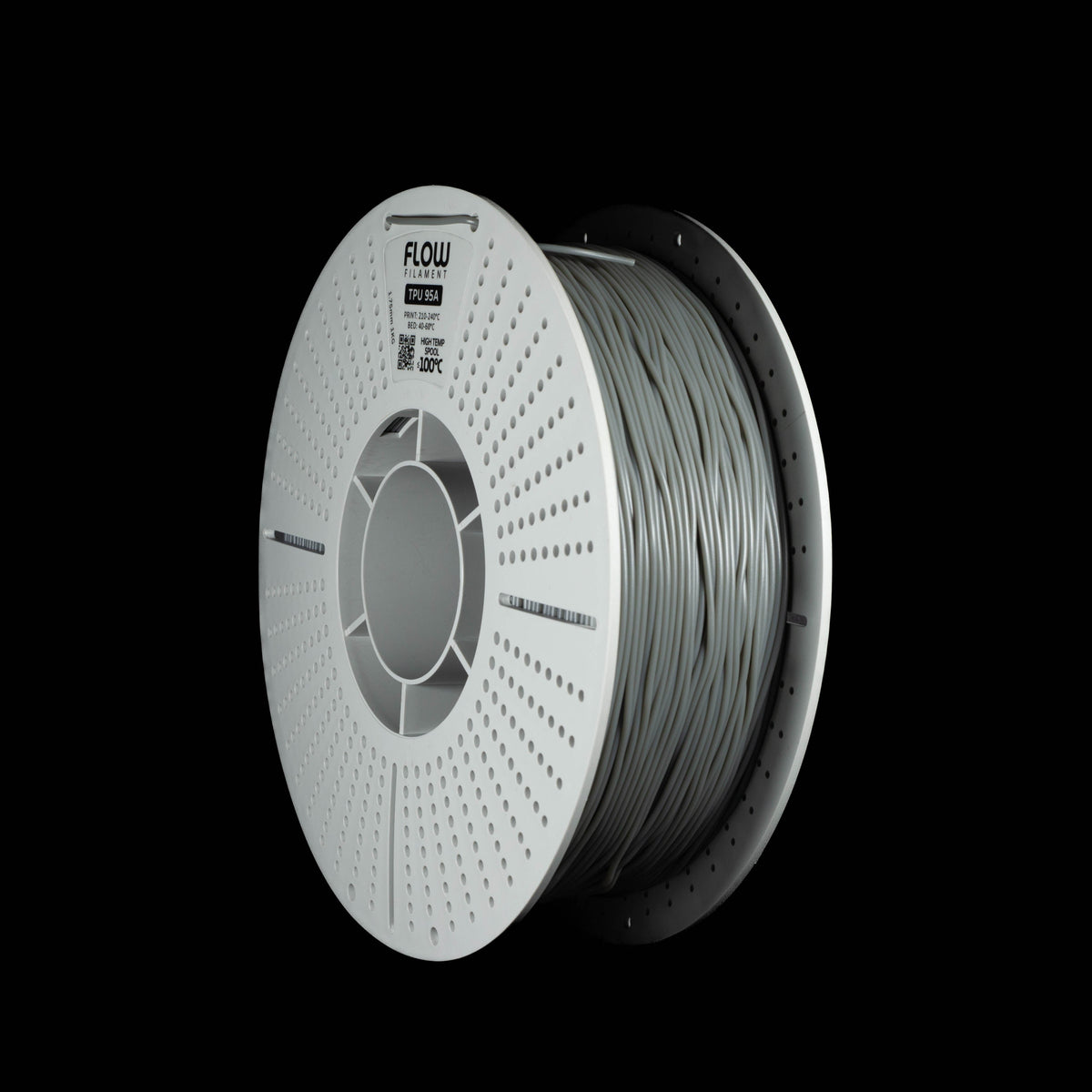 A spool of grey 3D printing filament, shown at a three-quarter angle against a solid black background. The spool is white perforated outer edge and features the brand name 'FLOW' printed on the top.