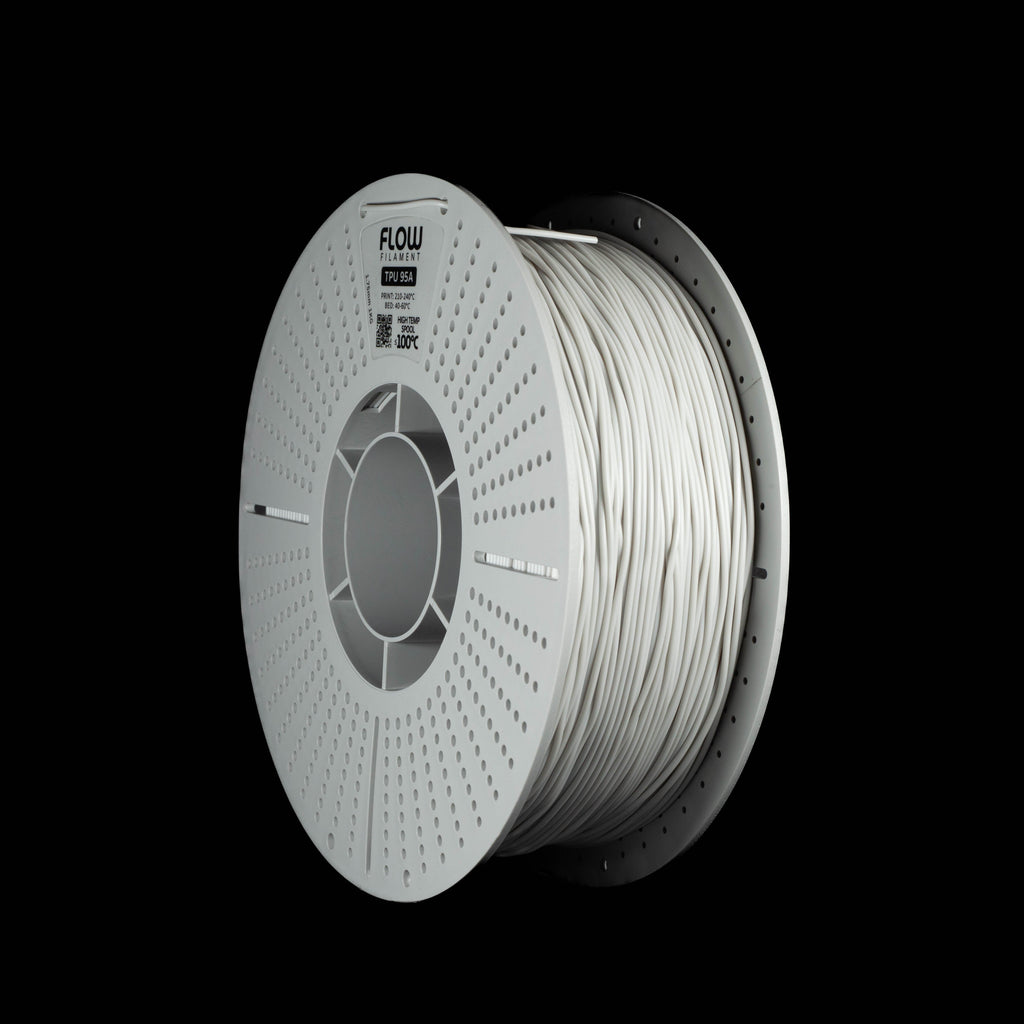 A spool of light grey 3D printing filament, shown at a three-quarter angle against a solid black background. The spool is white with a visible brand logo 'FLOW' on the top left.