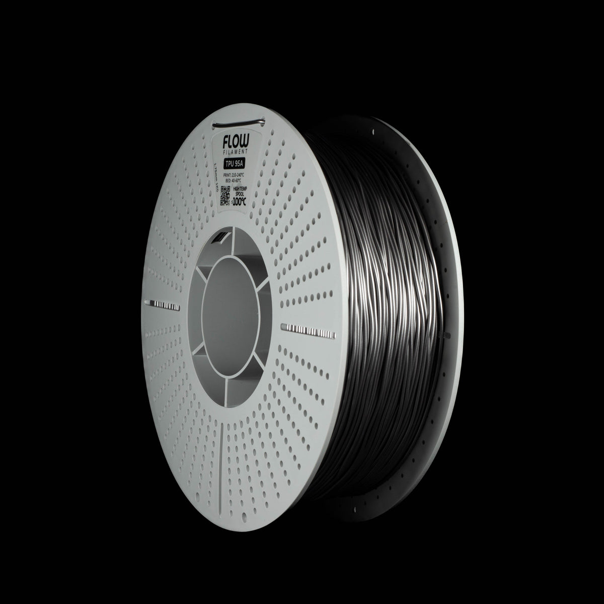 A spool of metallic space grey 3D printing filament on a solid black background, with the brand name FLOW visible on the top of the perforated spool.