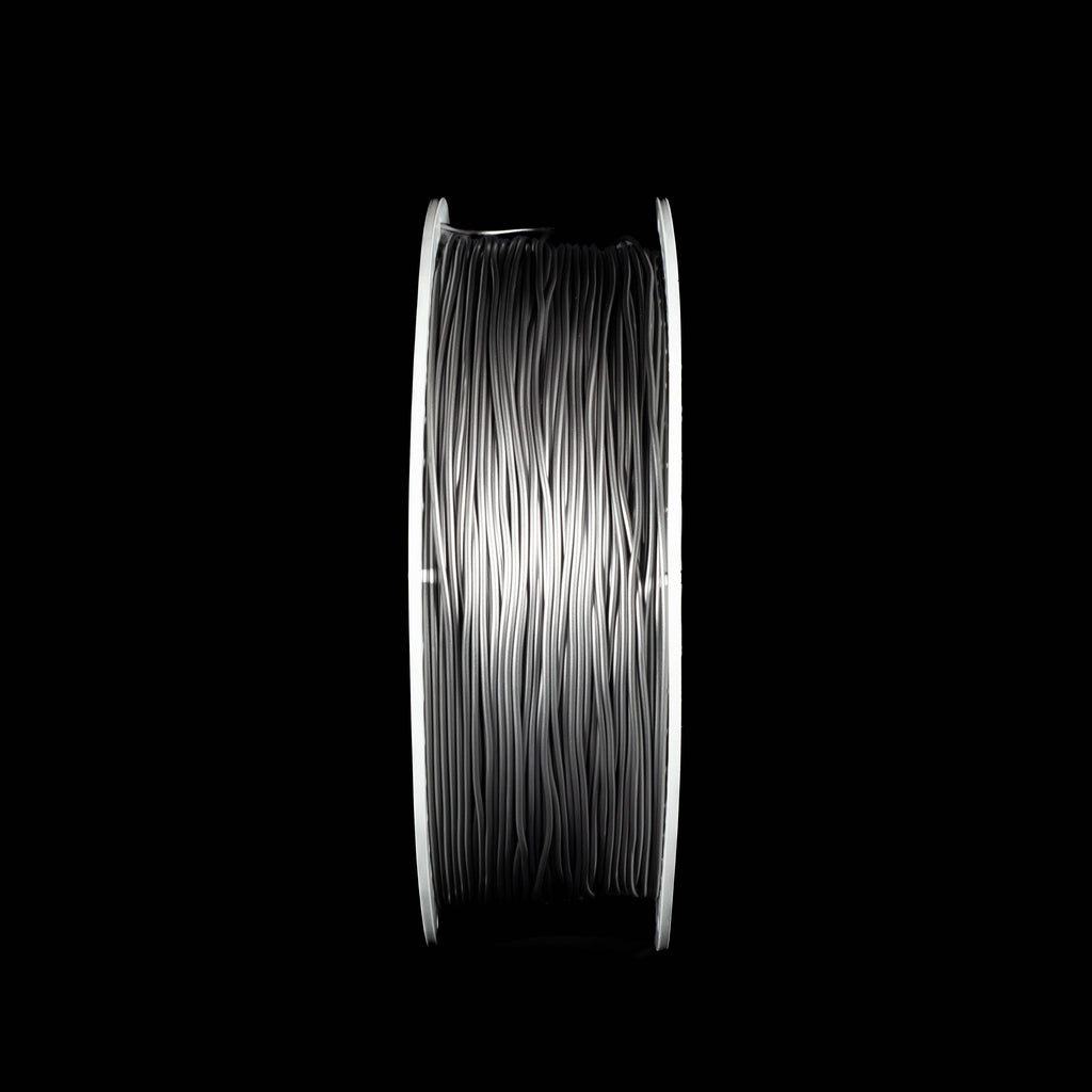 A spool of metallic space grey 3D printing filament on a solid black background.
