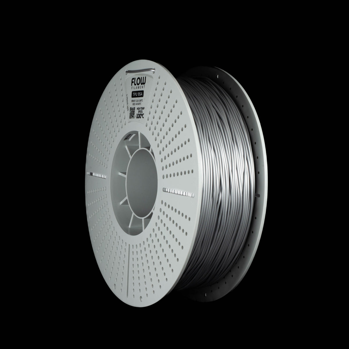 A spool of 3D printing filament, shown at a three-quarter angle against a solid black background. The spool is white with a perforated edge, and the filament itself is a metallic silver.