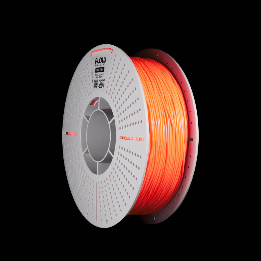 A spool of orange 3D printing filament on a white perforated spool, shown against a solid black background. The brand name 'FLOW' is visible on the top of the spool.