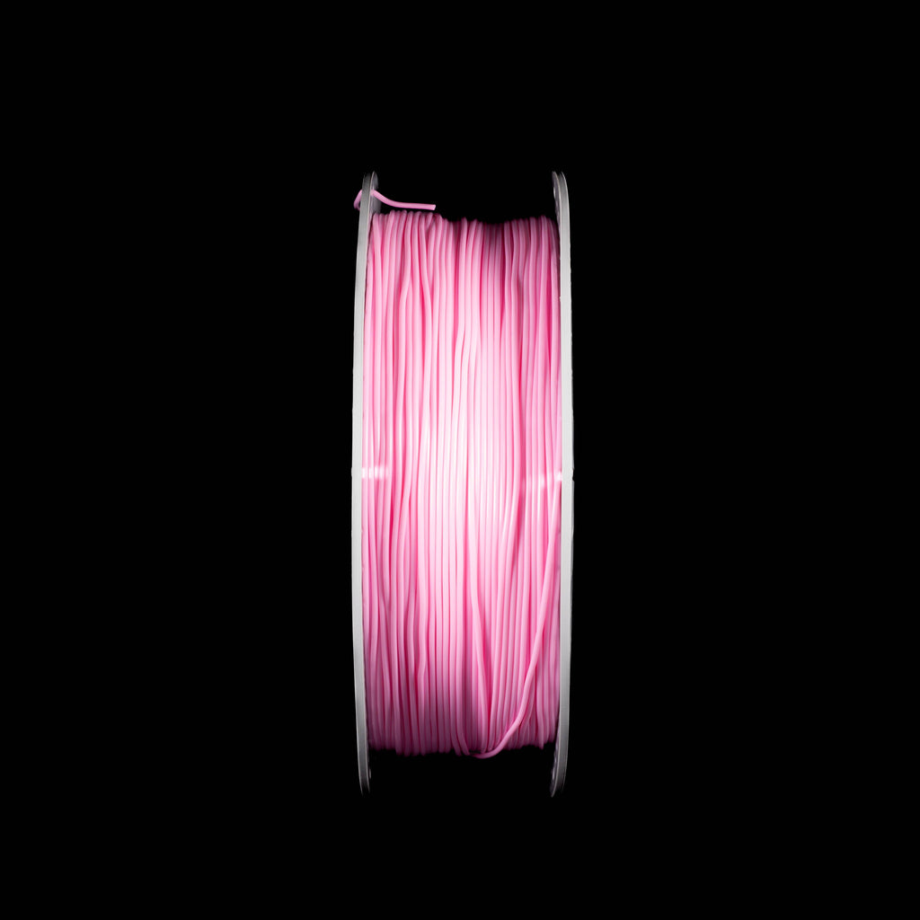 A spool of pink 3D printing filament wound on a white perforated spool, centered against a solid black background.