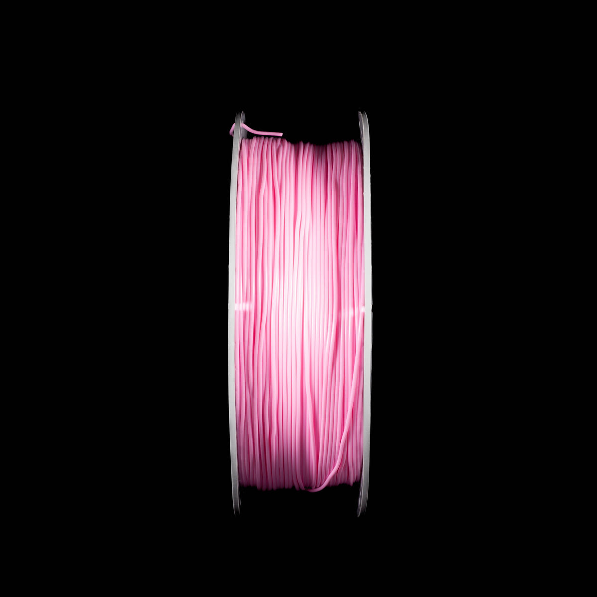 A spool of pink 3D printing filament wound on a white perforated spool, centered against a solid black background.