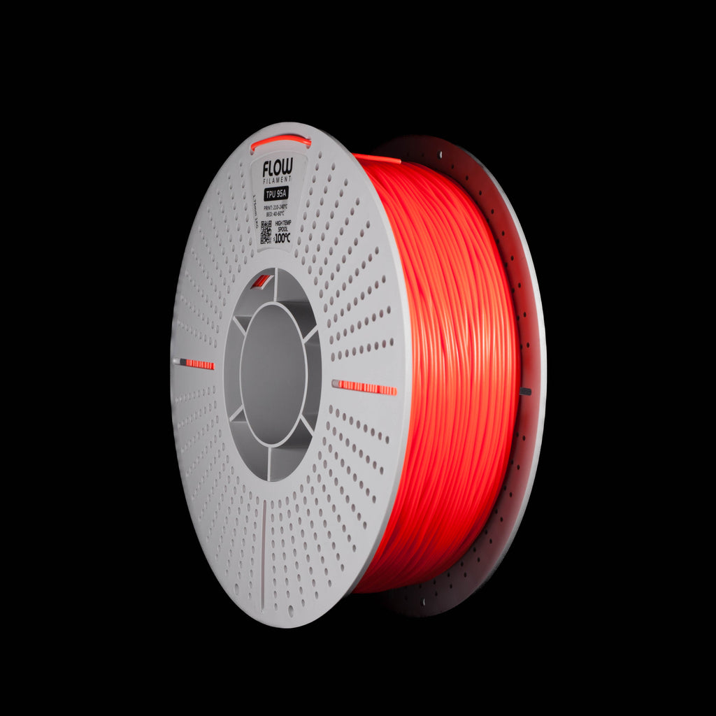 A spool of black 3D printer filament in red colour on a solid black background. The spool has a white outer rim with a circular vented pattern, with the brand name 'FLOW' printed on the spool.