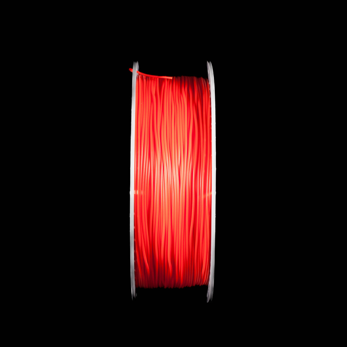A spool of bright red 3D printing filament in red colour centered against a solid black background.