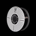A spool of translucent grey 3D printing filament with a white perforated spool, shown against a solid black background. The brand name 'FLOW' is visible on the top of the spool.