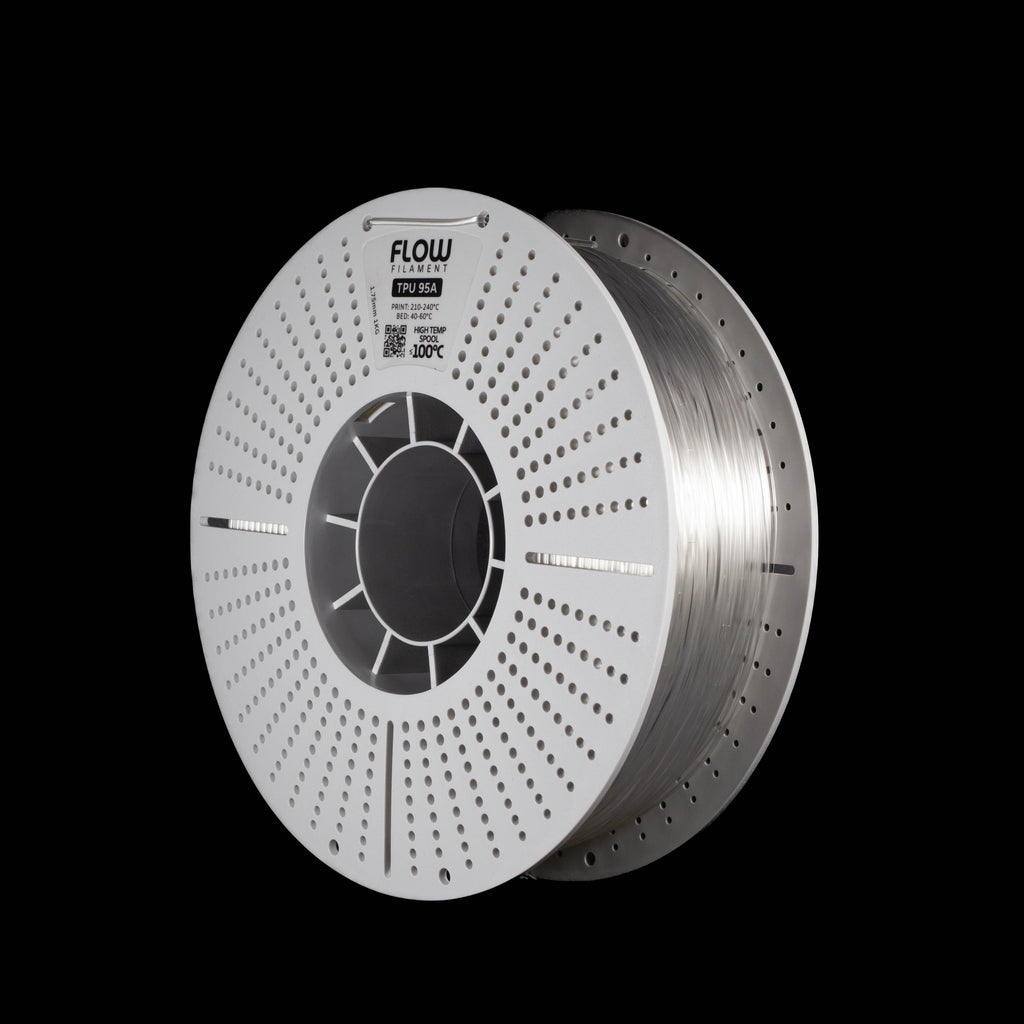 A spool of transparent filament on a white perforated spool, branded 'FLOW', shown on a solid black background.