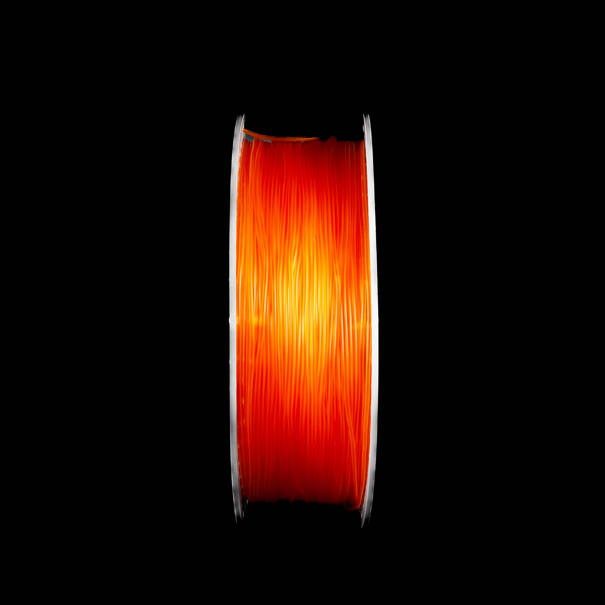 A spool of translucent orange 3D printing filament, shown vertically against a solid black background.