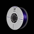A spool of  3D printer filament wounded on a white plastic core banded FLOW FILAMENT, showing the deep purple translucent filament material, set against a solid black background.