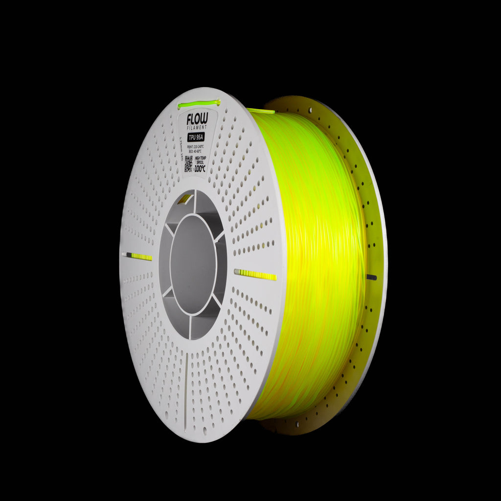 A spool of translucent yellow 3D printer filament on a solid black background. The spool is white perforated spool and features the brand name 'flow' printed on the top.