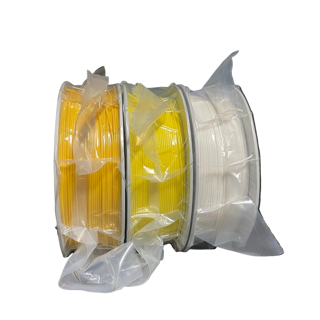 Three spools of 3D printer filament in yellow and white, wrapped in clear protective plastic.