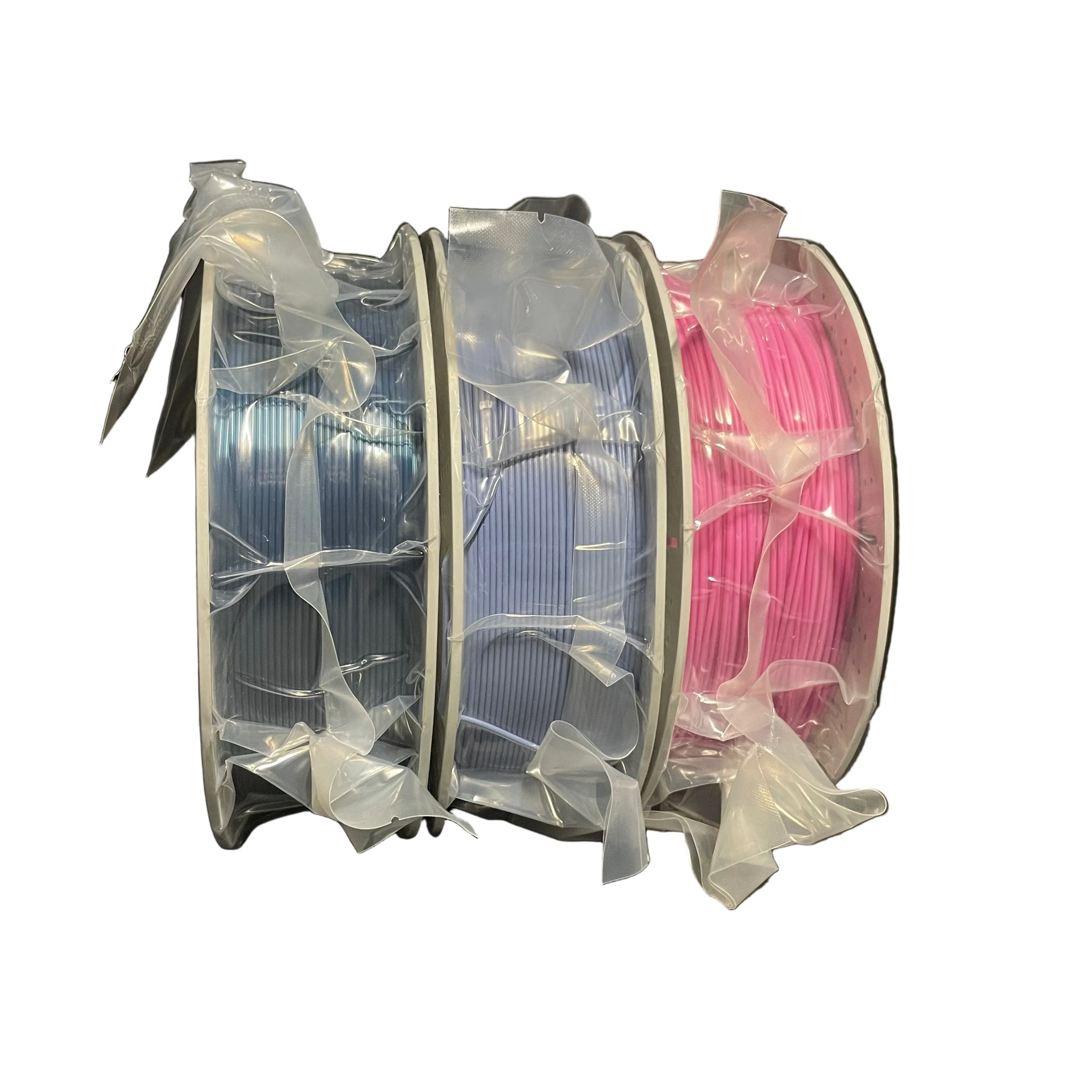 Three spools of 3D printer filament wrapped in clear plastic, showing light blue, lavender, and hot pink colors.